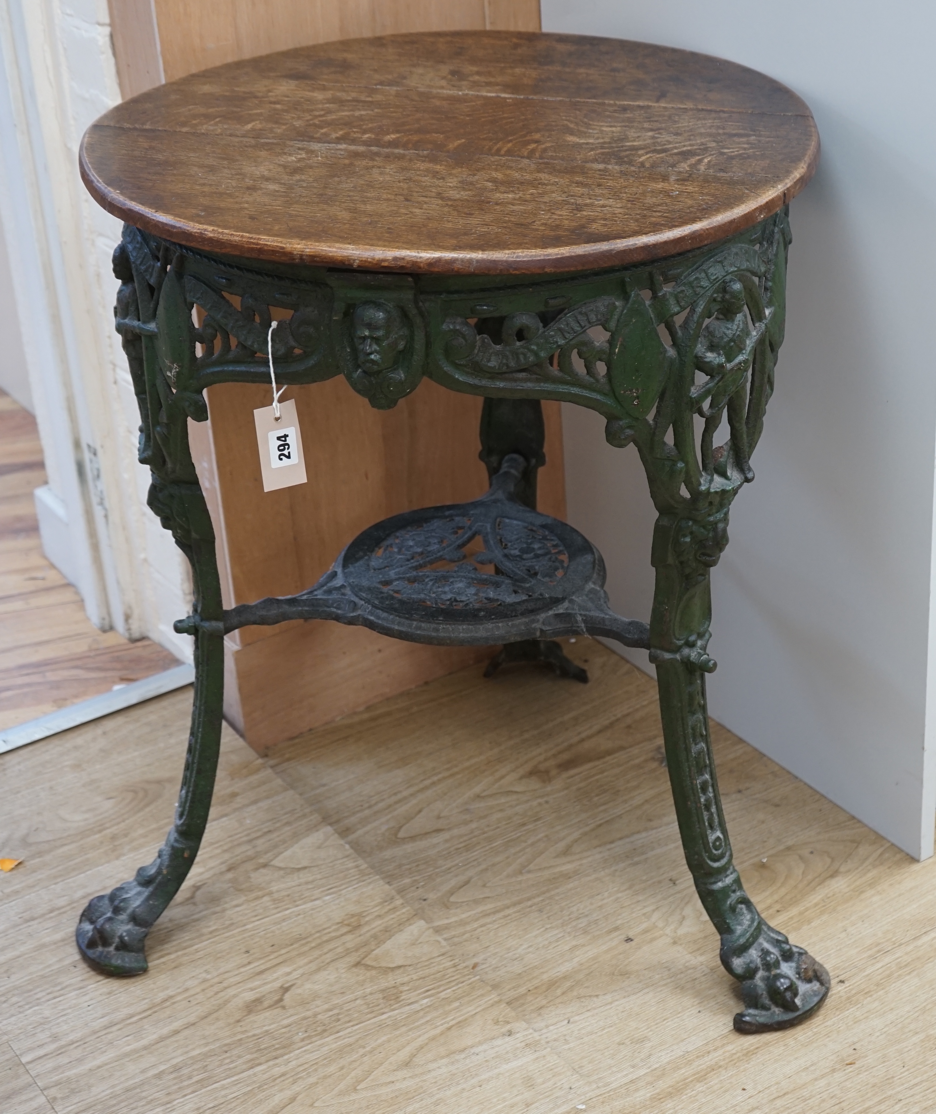 A rare early 20th century Boer War commemorative cast iron pub table, decorated with standing soldiers beneath Ladysmith, Pretoria and Mafeking scrolls, legs bearing registered number 364112, the circular oak top 62cm di